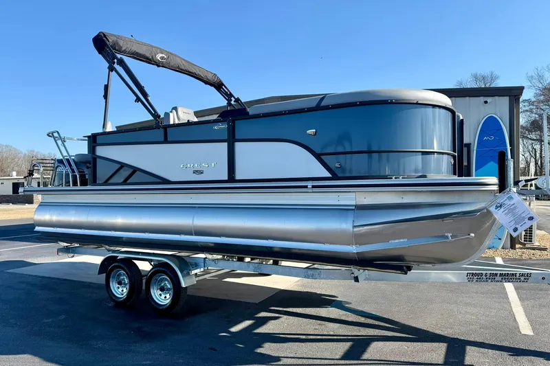 Slide: The Image of 2026 Crest Conquest 210 Fish pontoon boat on trailer, displayed outdoors. - 11