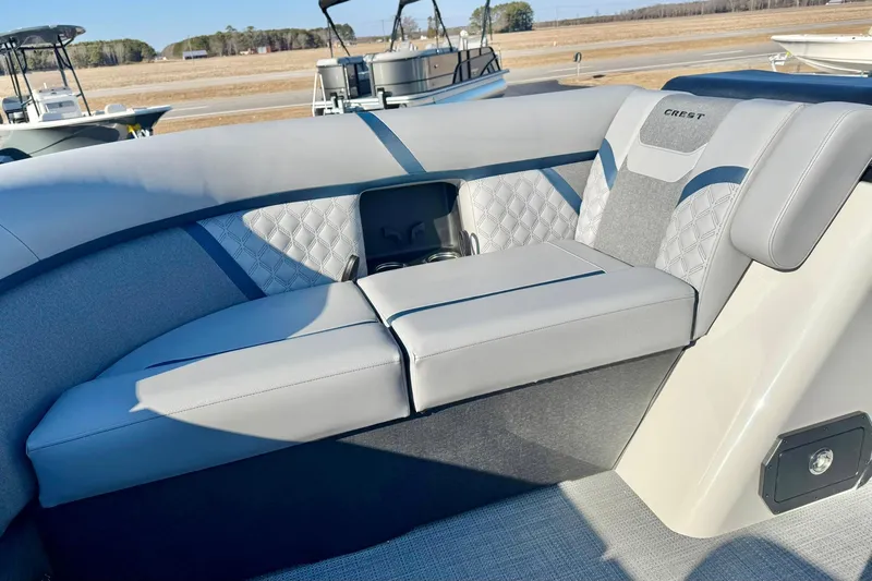 Slide: The Image of 2026 Crest Conquest 210 Fish boat interior with cushioned seating and elegant design. - 16