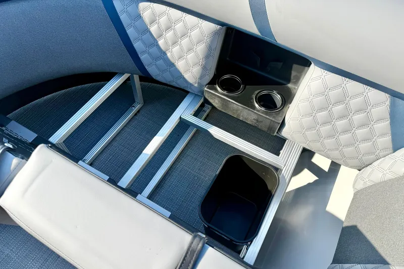 Slide: The Image of 2026 Crest Conquest 210 Fish boat interior with storage and cup holders. - 18