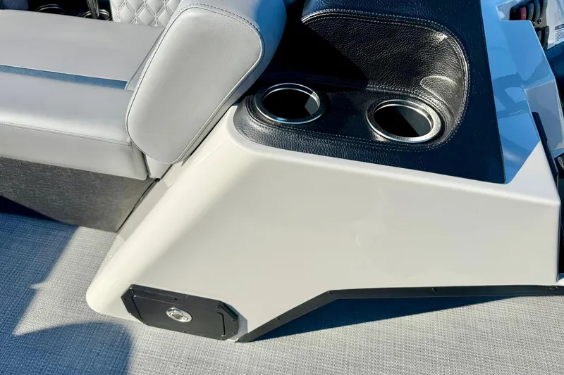 Slide: The Image of 2026 Crest Conquest 210 Fish boat interior with cup holders and cushioned seating. - 23