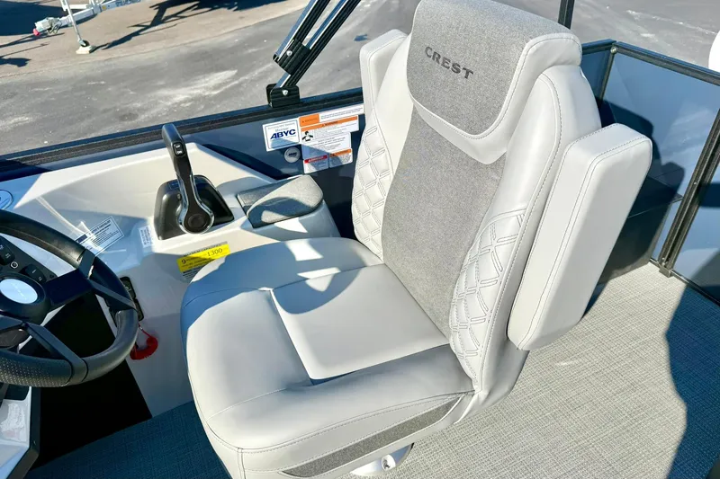 Slide: The Image of Captain's seat of 2026 Crest Conquest 210 Fish boat, featuring sleek design and controls. - 25