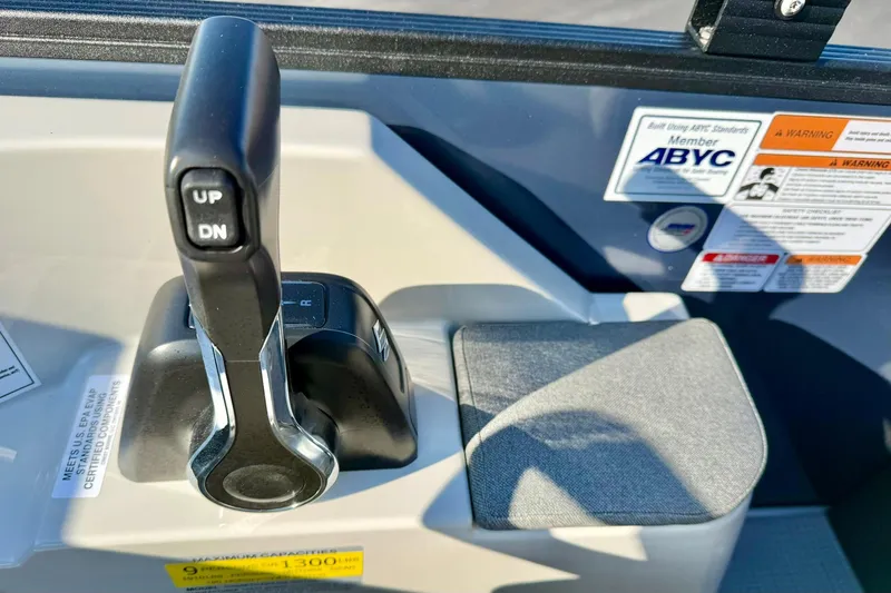 Slide: The Image of Throttle control of 2026 Crest Conquest 210 Fish boat with safety labels. - 31