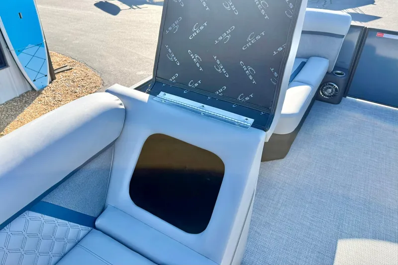 Slide: The Image of 2026 Crest Conquest 210 Fish boat interior with open storage compartment. - 35