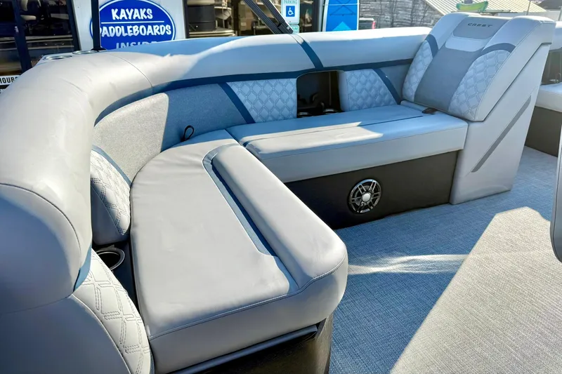 Slide: The Image of 2026 Crest Conquest 210 Fish boat interior with plush seating and modern design. - 38