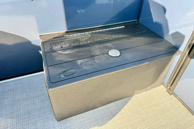 Slide: The Image of 2026 Crest Conquest 210 Fish boat storage compartment with ruler on lid. - 39