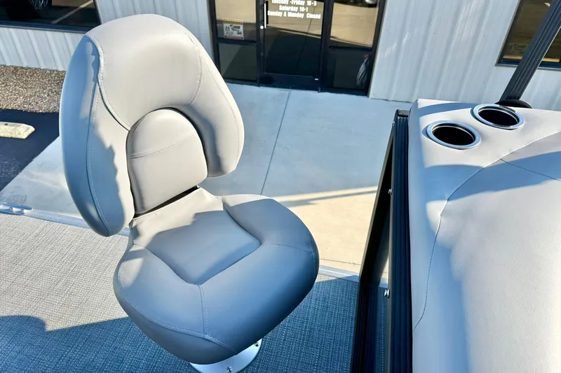 Slide: The Image of 2026 Crest Conquest 210 Fish boat seat with cup holders, outdoor setting. - 42