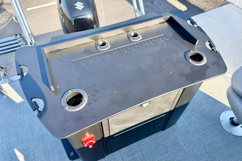 Slide: The Image of 2026 Crest Conquest 210 Fish boat console with rod holders and measurement guide. - 44