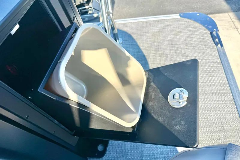 Slide: The Image of 2026 Crest Conquest 210 Fish boat with open storage compartment and latch. - 47