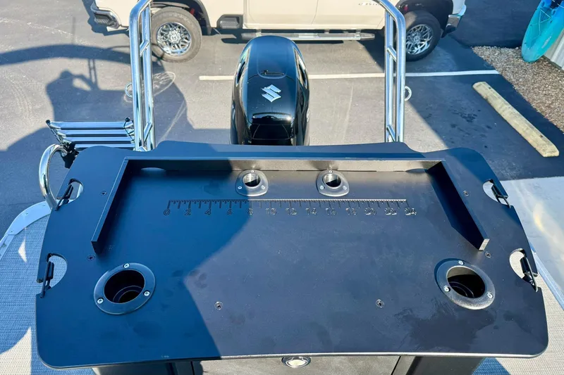 Slide: The Image of 2026 Crest Conquest 210 Fish boat with fishing station and motor, parked in a lot. - 49