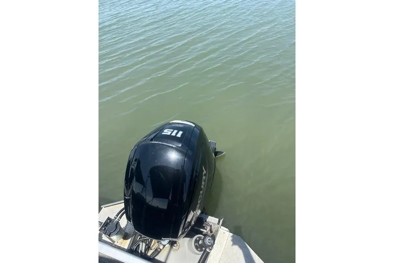 Slide: The Image of 2023 Cypress Cay Seabreeze 232 with Mercury outboard motor on calm water. - 11