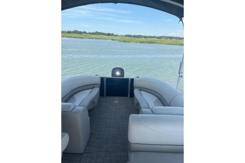 Slide: The Image of 2023 Cypress Cay Seabreeze 232 pontoon boat interior with lake view. - 7