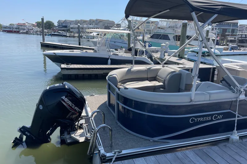 Slide: The Image of 2023 Cypress Cay Seabreeze 232 pontoon boat docked at marina with Mercury outboard. - 9