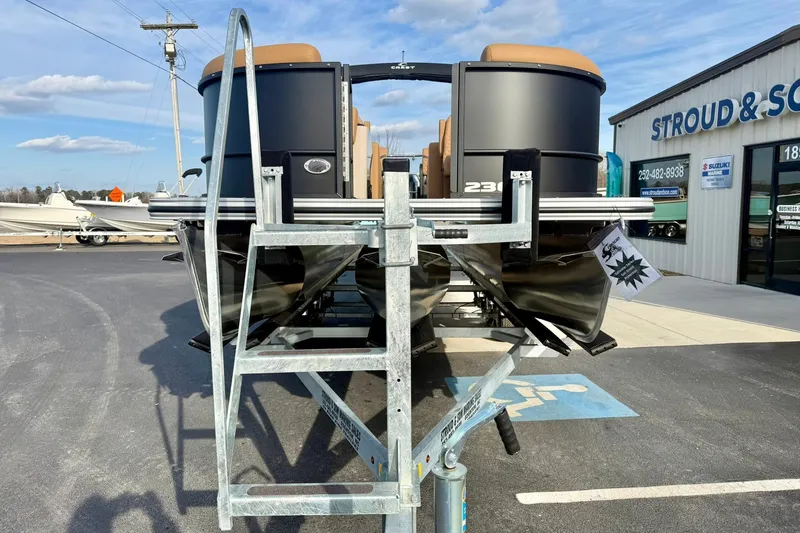 Slide: The Image of 2026 Crest Conquest 230 SLRC pontoon boat on trailer at dealership. - 10