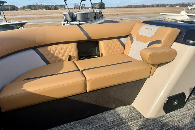 Slide: The Image of Luxurious seating on 2026 Crest Conquest 230 SLRC boat, featuring tan upholstery and modern design. - 13