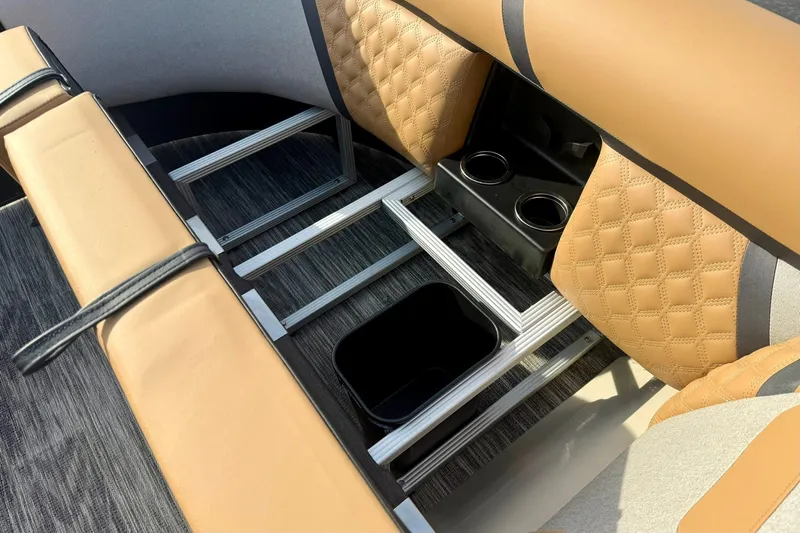 Slide: The Image of 2026 Crest Conquest 230 SLRC interior with tan quilted seats and cup holders. - 14