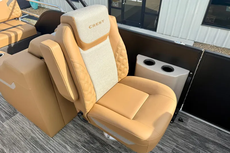 Slide: The Image of Luxurious tan seat on 2026 Crest Conquest 230 SLRC boat with cup holders. - 24