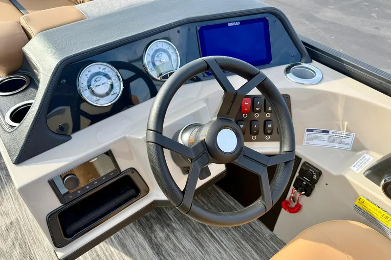 Slide: The Image of 2026 Crest Conquest 230 SLRC dashboard with steering wheel and control panel. - 28