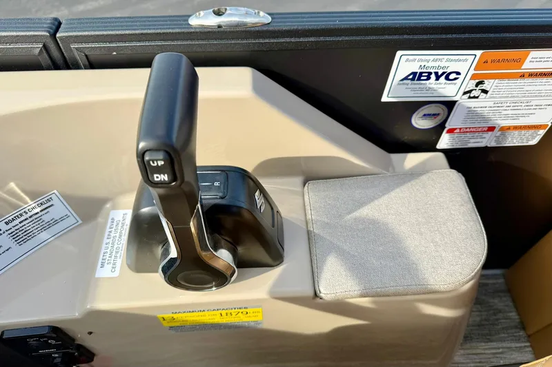 Slide: The Image of Control panel of 2026 Crest Conquest 230 SLRC boat with throttle lever and safety labels. - 29