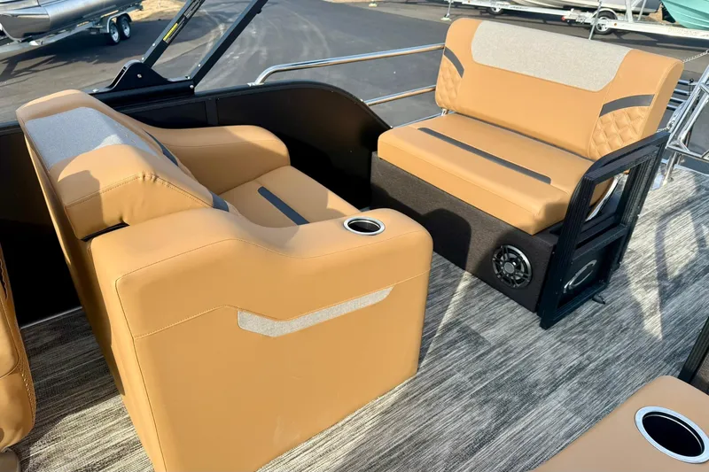 Slide: The Image of 2026 Crest Conquest 230 SLRC boat interior with tan seating and cup holders. - 31