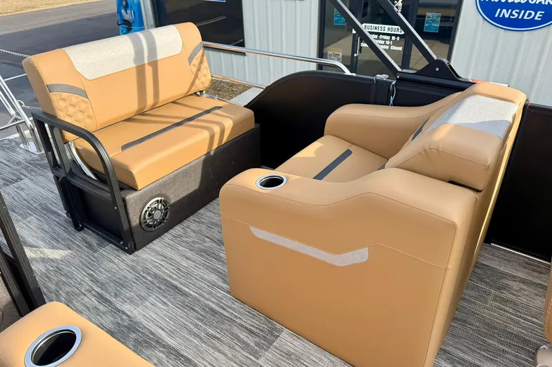 Slide: The Image of 2026 Crest Conquest 230 SLRC boat interior with tan seating and cup holders. - 32