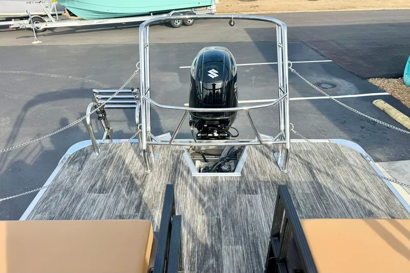 Slide: The Image of 2026 Crest Conquest 230 SLRC pontoon boat with Suzuki outboard motor, docked on pavement. - 36