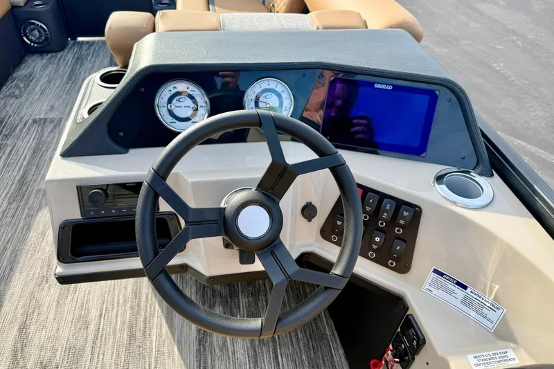 Slide: The Image of Steering console of 2026 Crest Conquest 230 SLRC boat with modern controls and gauges. - 5