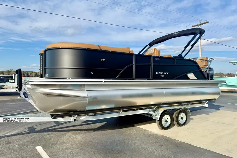 Slide: The Image of 2026 Crest Conquest 230 SLRC pontoon boat on trailer, black and silver design. - 7