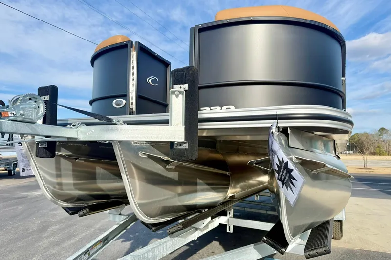 Slide: The Image of 2026 Crest Conquest 230 SLRC pontoon boat on trailer, showcasing sleek design. - 11
