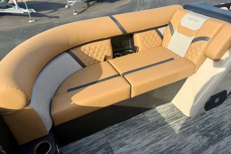 Slide: The Image of Luxurious seating on 2026 Crest Conquest 230 SLRC boat, featuring tan upholstery and cup holders. - 12