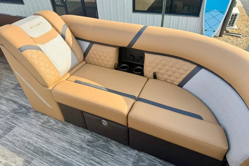 Slide: The Image of Luxurious seating on 2026 Crest Conquest 230 SLRC boat, featuring tan upholstery and cup holders. - 15