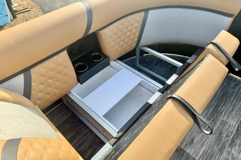 Slide: The Image of 2026 Crest Conquest 230 SLRC boat interior with tan seating and storage compartment. - 17