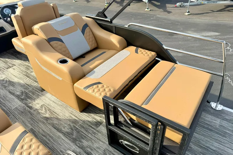 Slide: The Image of Luxurious seating on 2026 Crest Conquest 230 SLRC boat, featuring tan upholstery and cup holder. - 34