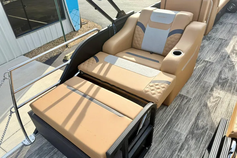 Slide: The Image of Luxurious seating on 2026 Crest Conquest 230 SLRC boat with tan upholstery and cup holder. - 35