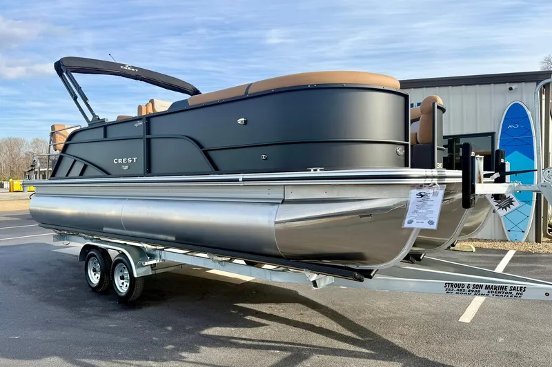 Slide: The Image of 2026 Crest Conquest 230 SLRC pontoon boat on trailer, displayed outdoors. - 8