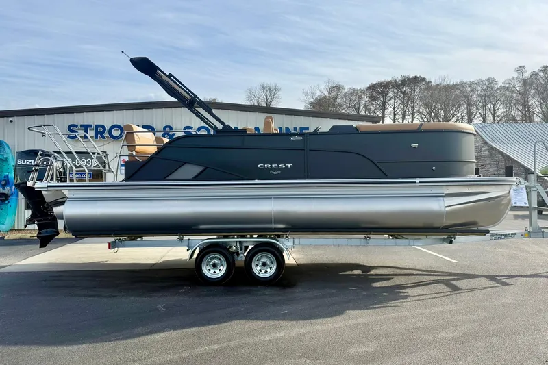 Slide: The Image of 2026 Crest Conquest 230 SLRC pontoon boat on trailer, parked outdoors. - 9