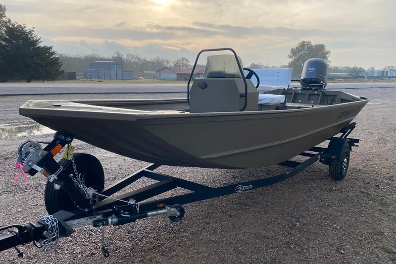 Slide: The Image of 2026 G3 Gator Tough 18 CCJ boat on trailer, parked outdoors. - 3