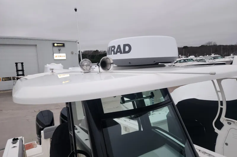 Slide: The Image of 2023 Boston Whaler 280 Outrage boat with radar and horn on roof. - 10