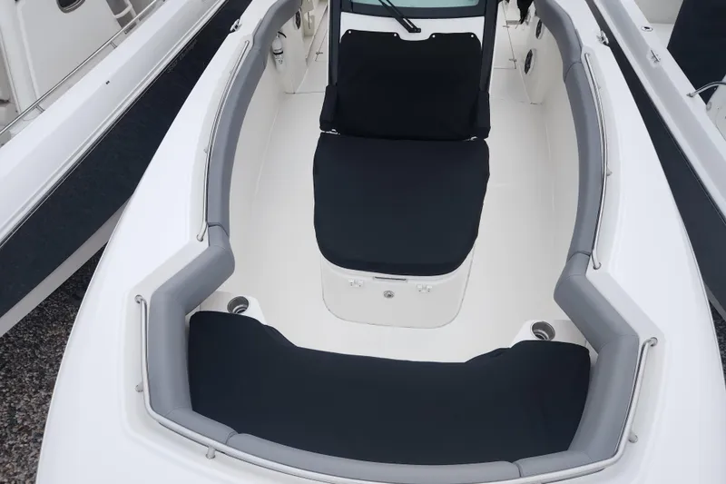 Slide: The Image of 2023 Boston Whaler 280 Outrage boat interior with cushioned seating and sleek design. - 13