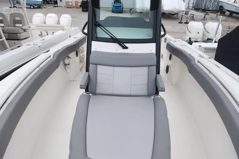 Slide: The Image of 2023 Boston Whaler 280 Outrage boat interior with gray seating and modern design. - 14