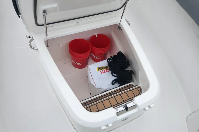 Slide: The Image of Storage compartment on 2023 Boston Whaler 280 Outrage with buckets and ropes. - 15