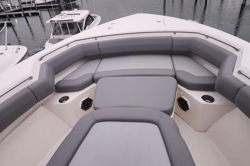 Slide: The Image of 2023 Boston Whaler 280 Outrage Trade In, featuring spacious gray seating area. - 17