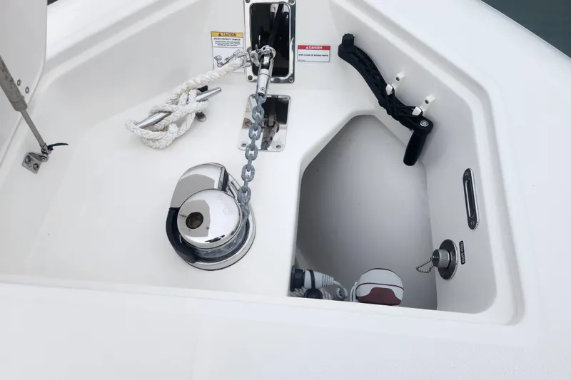 Slide: The Image of 2023 Boston Whaler 280 Outrage anchor compartment with chain and rope. - 18
