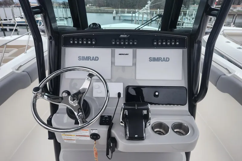 Slide: The Image of 2023 Boston Whaler 280 Outrage helm with Simrad electronics and Mercury controls. - 7