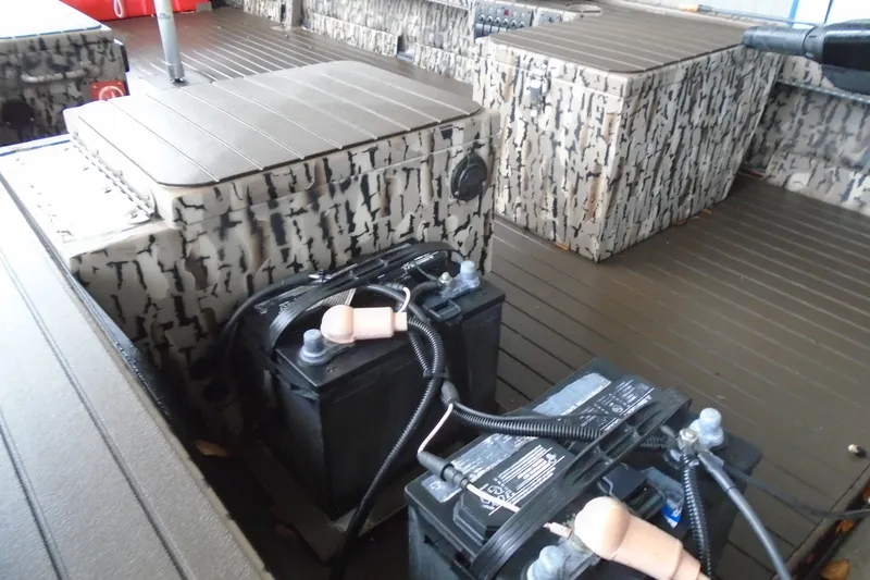 Slide: The Image of 2021 Pro-Drive SBX Series 17' boat interior with camouflage seating and dual batteries. - 11