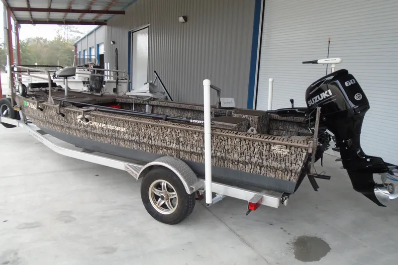 Slide: The Image of 2021 Pro-Drive SBX Series 17' boat with Suzuki 60 engine on trailer. - 18