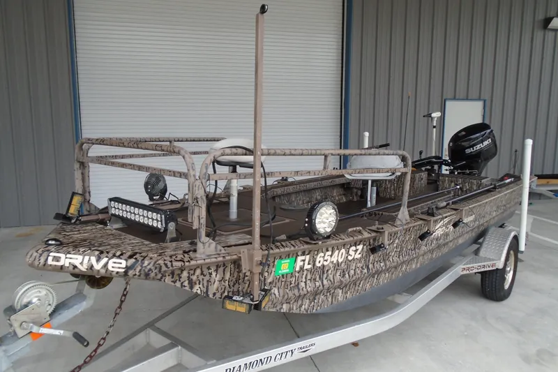 Slide: The Image of 2021 Pro-Drive SBX Series 17' boat with camouflage design on a trailer. - 19