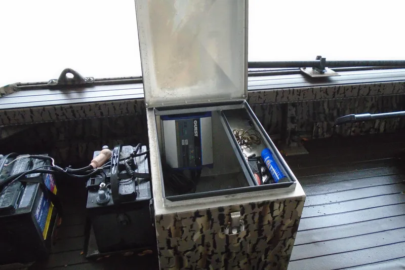 Slide: The Image of 2021 Pro-Drive SBX Series 17' boat interior with open storage compartment and battery. - 21