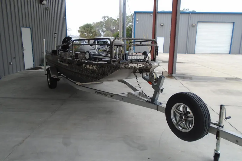 Slide: The Image of 2021 Pro-Drive SBX Series 17' boat on trailer in industrial setting. - 3