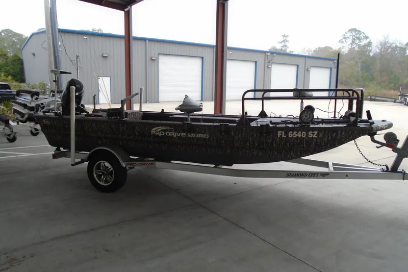 Slide: The Image of 2021 Pro-Drive SBX Series 17' boat on trailer in industrial setting. - 4