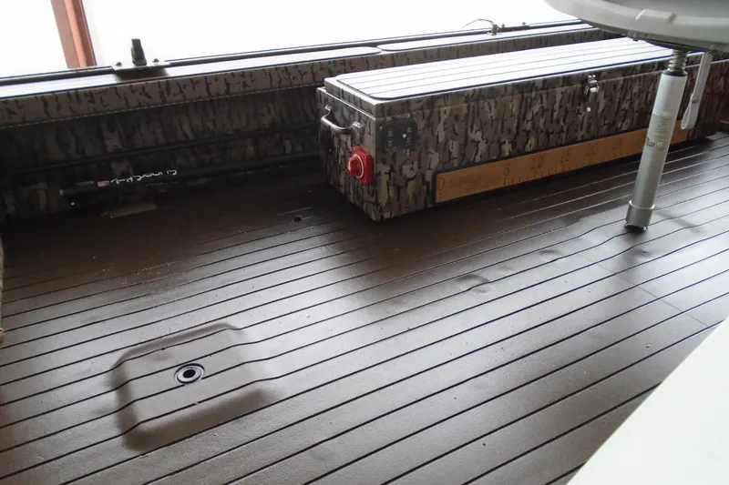 Slide: The Image of 2021 Pro-Drive SBX Series 17' boat interior with camo storage box and ruler. - 7